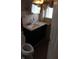 Updated bathroom featuring a modern black vanity with light countertop and white tiled walls, offering a clean aesthetic at 548 S Vine St, Indianapolis, IN 46241