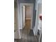 Hallway with grey walls and white trim showcases updated flooring leading to adjacent rooms, including the bathroom at 548 S Vine St, Indianapolis, IN 46241