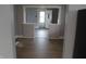 View of the home's interior with newly-installed wood floors, looking towards the front door at 548 S Vine St, Indianapolis, IN 46241