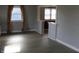 Bright living room with stylish gray walls, wood-look floors and abundant natural light through large windows at 548 S Vine St, Indianapolis, IN 46241