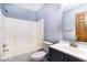 This bathroom features a shower-tub combination, a modern vanity, and neutral color palette at 5634 Wynridge Ct, Indianapolis, IN 46235