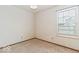 This simple bedroom has carpeted floor and a window for natural light at 5634 Wynridge Ct, Indianapolis, IN 46235