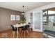 Cozy dining room features hardwood floors, modern lighting, and a sliding door to a screened in porch at 5634 Wynridge Ct, Indianapolis, IN 46235