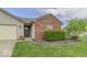 Close up of single-story home with siding and brick, attached garage and driveway at 5634 Wynridge Ct, Indianapolis, IN 46235