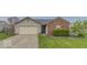 Single-Gathering home with brick and siding, attached two-car garage, and driveway at 5634 Wynridge Ct, Indianapolis, IN 46235