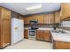 Well-lit kitchen features stainless steel appliances, ample cabinet space, and easy-to-clean flooring at 5634 Wynridge Ct, Indianapolis, IN 46235