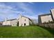 Green backyard with lush grass and view of the back exterior of the home at 5828 Long Lake Ln, Indianapolis, IN 46235