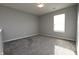 A bright bedroom with large windows and plush carpeting at 5828 Long Lake Ln, Indianapolis, IN 46235