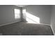 Sunlit bedroom with neutral walls and plush carpeting at 5828 Long Lake Ln, Indianapolis, IN 46235
