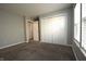 This carpeted bedroom includes a closet, and a double window for natural lighting at 5828 Long Lake Ln, Indianapolis, IN 46235