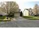 View of the home's front exterior, showcasing the lawn and curb appeal at 5828 Long Lake Ln, Indianapolis, IN 46235