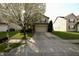 Charming home with a blooming tree in the front yard at 5828 Long Lake Ln, Indianapolis, IN 46235