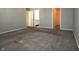 Spacious main bedroom with gray walls and carpet, leading to the bathroom and closet at 5828 Long Lake Ln, Indianapolis, IN 46235