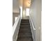 Carpeted stairway with white handrail leading to the upper level of the home at 5828 Long Lake Ln, Indianapolis, IN 46235