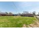 Spacious backyard with lush lawn, mature trees, and ample space for outdoor activities at 594 Daugherty St, Columbus, IN 47201