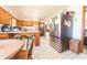 Spacious eat-in kitchen featuring vintage cabinets, stainless appliances, and a connected dining area at 594 Daugherty St, Columbus, IN 47201