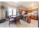 Eat-in kitchen with wooden cabinets, stainless steel appliances, and a quaint dining area with natural light at 594 Daugherty St, Columbus, IN 47201