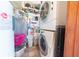 Laundry room with washer, dryer, and storage shelves at 594 Daugherty St, Columbus, IN 47201