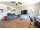 Inviting living room with hardwood floors, a modern ceiling fan, and a comfortable leather reclining sofa at 594 Daugherty St, Columbus, IN 47201