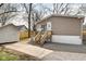 Exterior view of a home featuring a porch, shed, and gravel driveway, highlighting its outdoor amenities at 611 Victor Pl, Shelbyville, IN 46176