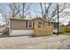 Well-maintained home with a porch, light gray exterior, dark red shutters, and gravel landscaping at 611 Victor Pl, Shelbyville, IN 46176