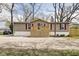 A single-story home with a wooden porch and red shutters on the windows, showcasing its curb appeal at 611 Victor Pl, Shelbyville, IN 46176