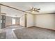Open concept living room with carpet, ceiling fan, and view to dining area showcasing the home's layout at 611 Victor Pl, Shelbyville, IN 46176