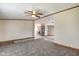 Living room with neutral carpet, trim, ceiling fan and a view to the dining area and kitchen at 611 Victor Pl, Shelbyville, IN 46176