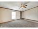 Living room with neutral carpet, trim, ceiling fan and a view to the front door at 611 Victor Pl, Shelbyville, IN 46176