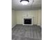 Cozy basement room features neutral carpet and an electric fireplace with mantel at 6186 Ralston Ave, Indianapolis, IN 46220