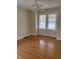 Bright bedroom with hardwood floors, ceiling fan, and double windows allowing natural light at 6186 Ralston Ave, Indianapolis, IN 46220