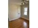 Sunlit bedroom with beautiful hardwood floors, and a classic white door for easy access at 6186 Ralston Ave, Indianapolis, IN 46220