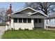 Charming home featuring a manicured lawn, inviting facade, and craftsman architectural details at 6186 Ralston Ave, Indianapolis, IN 46220