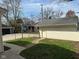 A detached garage on a sunny lot is accessible via a concrete path and offers extra storage at 6186 Ralston Ave, Indianapolis, IN 46220