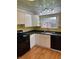 Galley kitchen featuring modern appliances, stylish backsplash, and ample cabinet space at 6186 Ralston Ave, Indianapolis, IN 46220