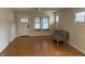 Cozy living room with hardwood floors, ample natural light, and a charming decorative chair at 6186 Ralston Ave, Indianapolis, IN 46220