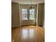 Bright living room featuring beautiful hardwood floors and a classic chandelier with windows at 6186 Ralston Ave, Indianapolis, IN 46220