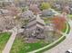 A peaceful neighborhood is showcased in this aerial shot featuring cozy homes and verdant trees at 622 Conner Creek Dr, Fishers, IN 46038
