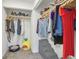 Walk-in closet with organized clothing, shelving, and dog accessories at 622 Conner Creek Dr, Fishers, IN 46038