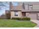Charming townhome exterior with stone accents, well-manicured landscaping, and a red front door at 622 Conner Creek Dr, Fishers, IN 46038
