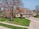 Charming home featuring a three-car garage, well-kept lawn, and mature landscaping at 622 Conner Creek Dr, Fishers, IN 46038