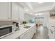 Modern kitchen offering a view of the dining area and outdoor patio through sliding glass doors at 622 Conner Creek Dr, Fishers, IN 46038