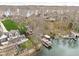 Aerial view of a lakefront neighborhood, showcasing docks and boat lifts, with a lush green lawn at 6948 Eagle Dr, Nineveh, IN 46164