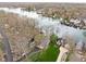 Aerial view of a lakefront neighborhood, showcasing well-manicured lawns and a putting green at 6948 Eagle Dr, Nineveh, IN 46164