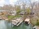 Stunning aerial view of a lakefront property with multiple docks and lush greenery at 6948 Eagle Dr, Nineveh, IN 46164