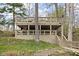 Multi-level deck with lush greenery, and outdoor seating, ideal for enjoying the natural surroundings at 6948 Eagle Dr, Nineveh, IN 46164