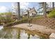 Stunning lakeside backyard featuring a stone wall and a sandy beach area, ideal for relaxation at 6948 Eagle Dr, Nineveh, IN 46164