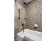 Elegant bathroom featuring neutral colored mosaic tiles, a shower head, and a tub at 6948 Eagle Dr, Nineveh, IN 46164