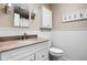 Classic bathroom featuring wainscoting, granite countertop and white vanity with a decorative mirror at 6948 Eagle Dr, Nineveh, IN 46164