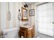 Bathroom features a toilet, a sink with wooden cabinets, and a mirror at 6948 Eagle Dr, Nineveh, IN 46164